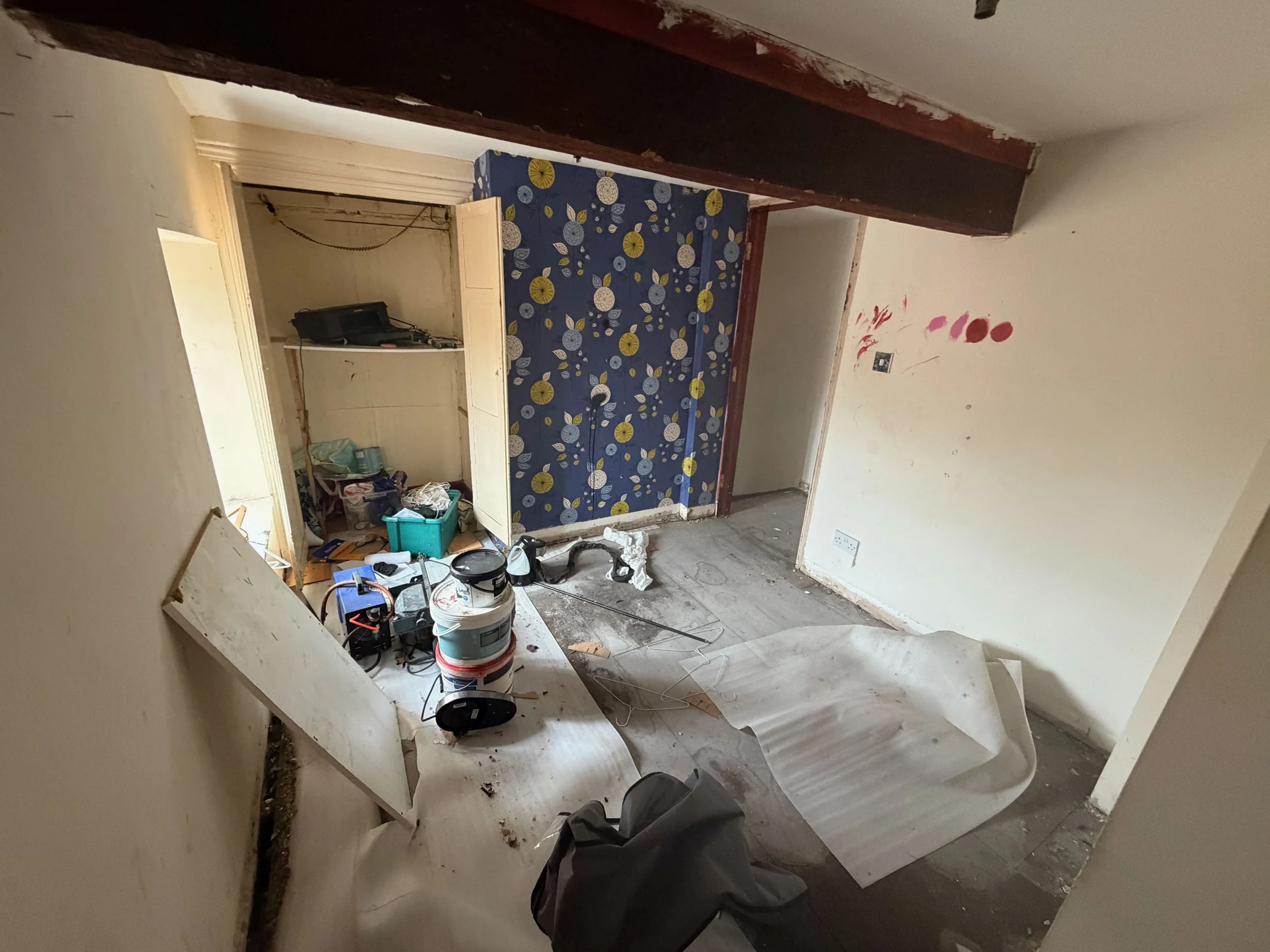 An upstairs room showing exposed timber before refurbishment