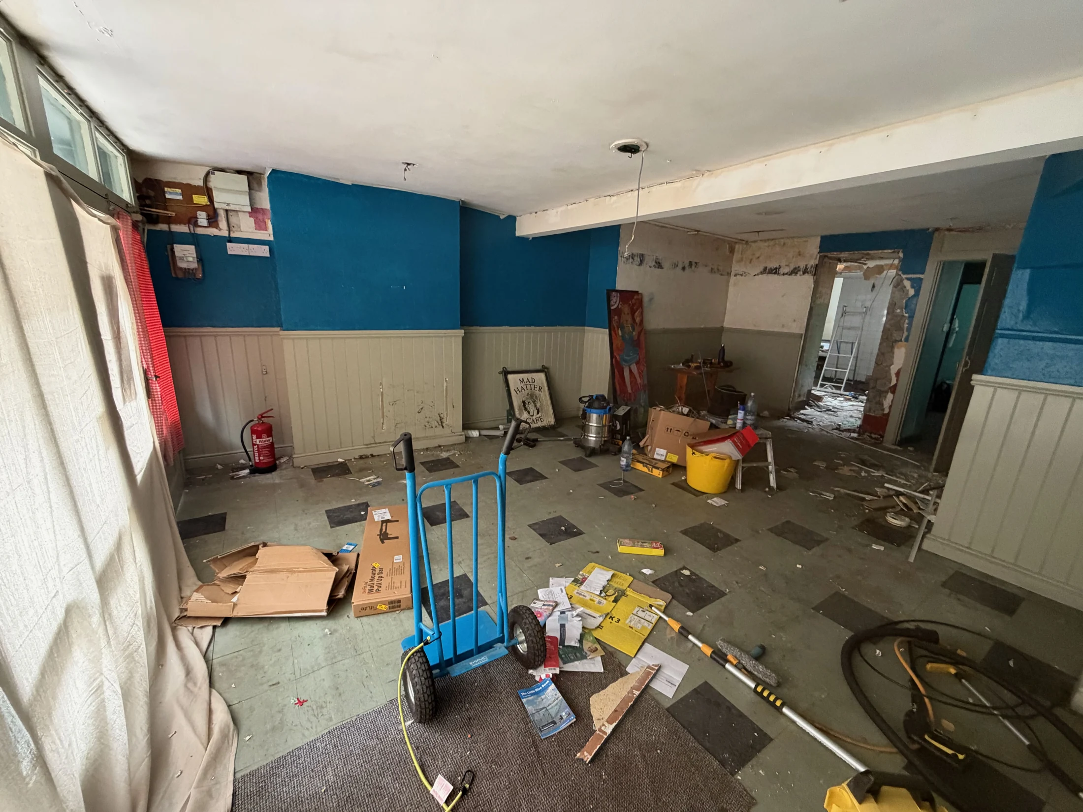 The café interior with blue walls and a chequered floor